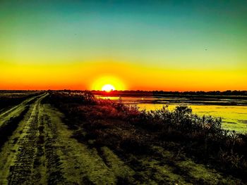 Scenic view of field against sky during sunset