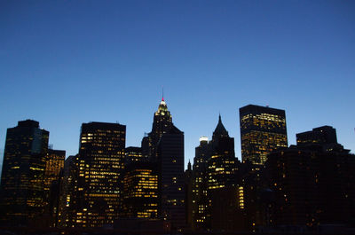 Illuminated buildings against clear sky