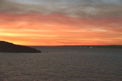 Scenic view of sea against orange sky