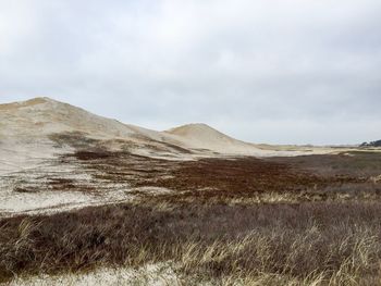 Scenic view of mountains against cloudy sky
