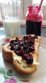 Close-up of blueberry jam on bread served on plate