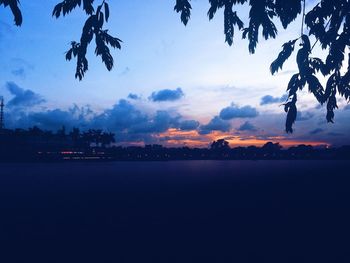 Scenic view of silhouette trees against sky at sunset