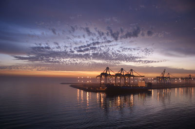 Pier on sea at sunset