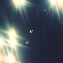 Low angle view of illuminated lights at night