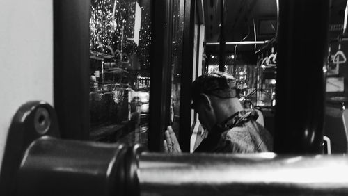 Portrait of man looking through window