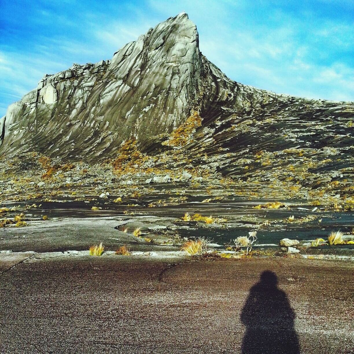 mountain, sky, tranquil scene, tranquility, scenics, beauty in nature, nature, cloud - sky, sunlight, cloud, rock formation, mountain range, rock - object, landscape, unrecognizable person, leisure activity, lifestyles, day