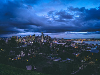 High angle view of illuminated buildings in city at dusk