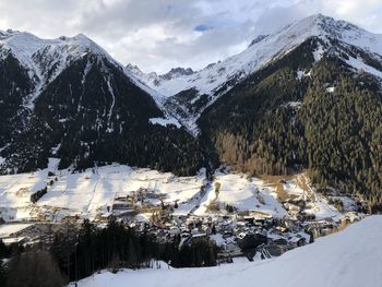 Scenic view of snow covered mountains against sky