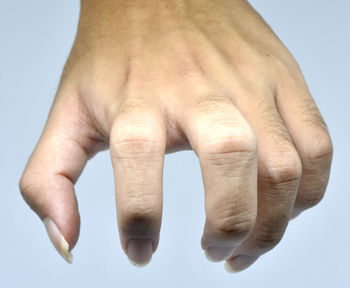 Close-up of hands over white background