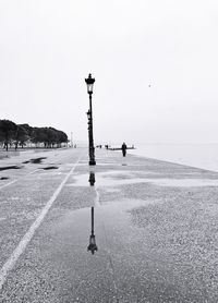 Street light on beach against clear sky