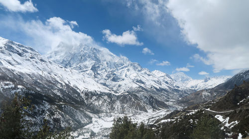 Scenic view of snowcapped mountains against sky