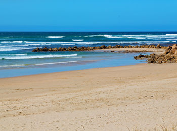 Scenic view of beach against clear sky