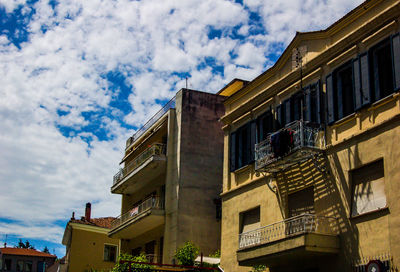 Low angle view of building against cloudy sky