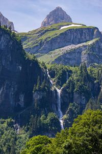 Scenic view of waterfall against sky