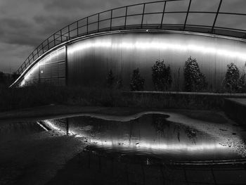 Low angle view of illuminated bridge against sky at night