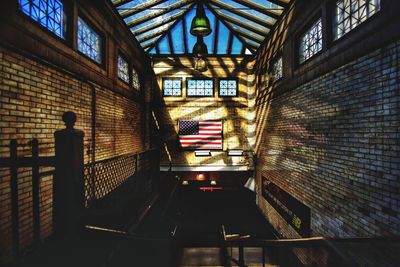 Rear view of man walking on staircase of building
