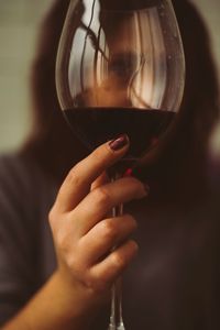 Midsection of woman drinking glass