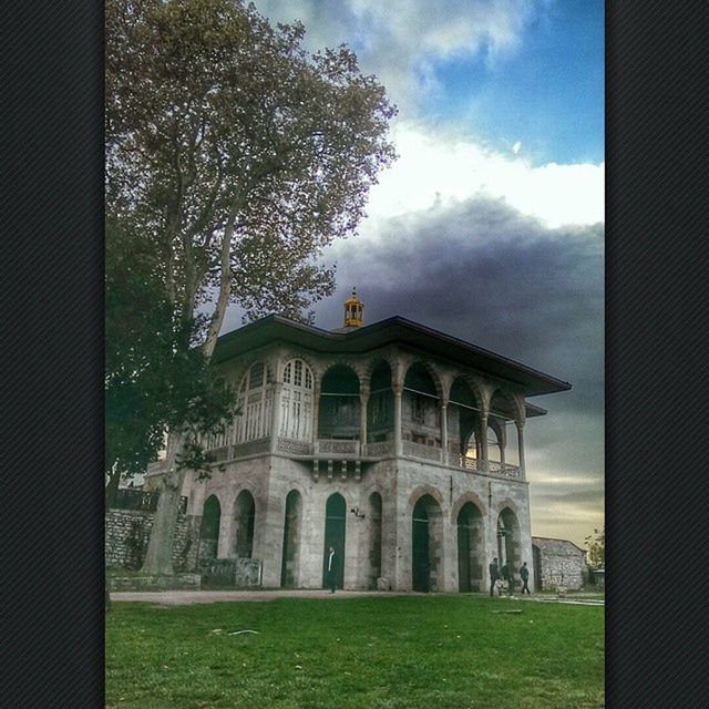architecture, built structure, building exterior, sky, grass, cloud - sky, tree, history, arch, window, lawn, cloud, famous place, travel destinations, architectural column, day, outdoors, the past, green color, old