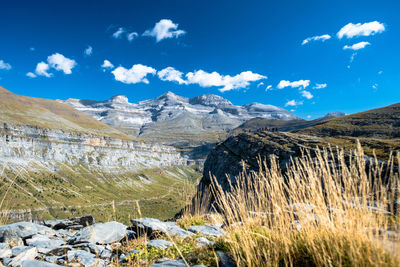 Scenic view of mountains against blue sky