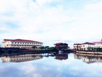 Reflection of houses in calm lake