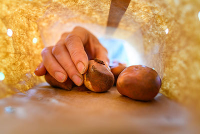 Cropped hand of man holding food