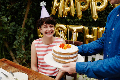 Smiling birthday woman sitting outdoors