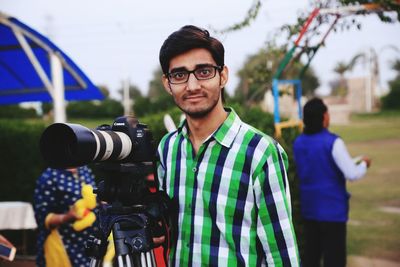 Portrait of young man photographing