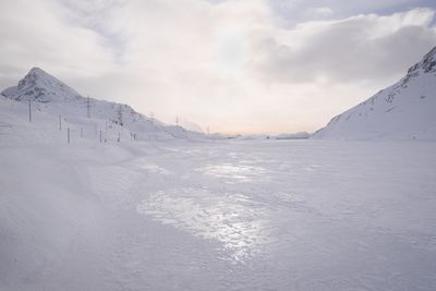 Scenic view of frozen lake against sky in winter