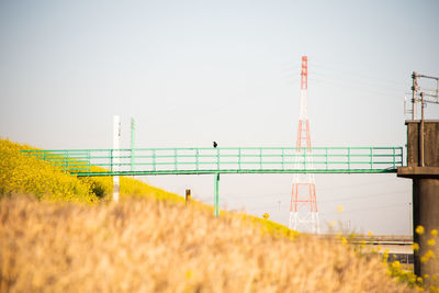 Bridge on field against clear sky