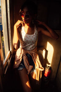 Young woman sitting at home