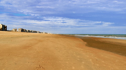 View of beach against cloudy sky