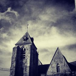 Low angle view of building against cloudy sky