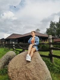 Portrait of teenage girl sitting on grass