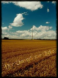 Scenic view of field against cloudy sky