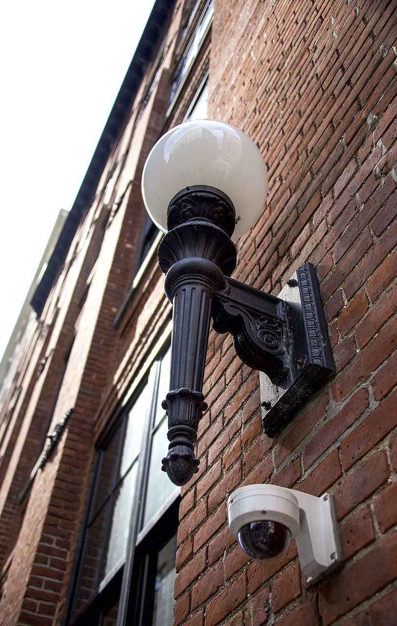 building exterior, architecture, low angle view, built structure, building, modern, brick wall, city, no people, street light, day, tall - high, tower, lighting equipment, outdoors, office building, technology, residential building, wall - building feature, window