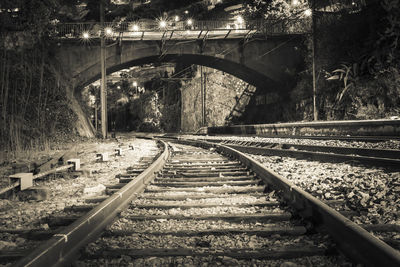 Railroad tracks amidst bridge