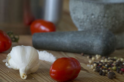 Close-up of ingredients with mortar and pestle on table