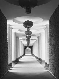 Illuminated light bulbs hanging from ceiling of temple