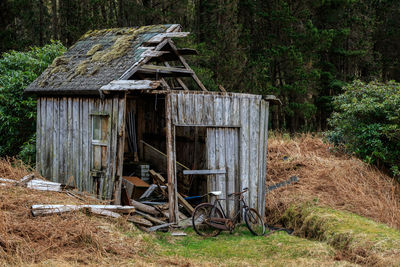 Old wooden house on field