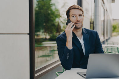 Mid adult man using smart phone