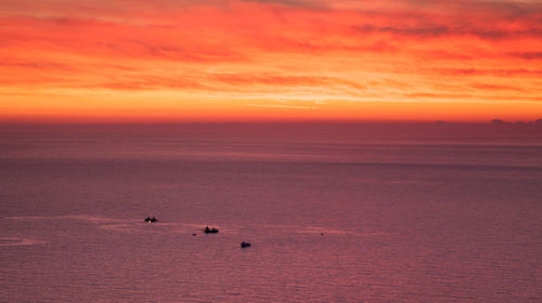 Scenic view of sea against orange sky