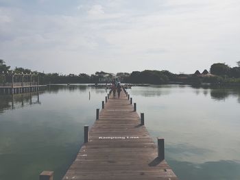 Pier over lake against sky