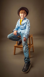 Portrait of boy sitting on chair