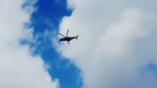 Low angle view of airplane flying in sky