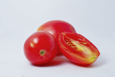 Close-up of tomatoes against white background