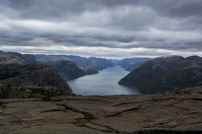 Scenic view of mountains against cloudy sky