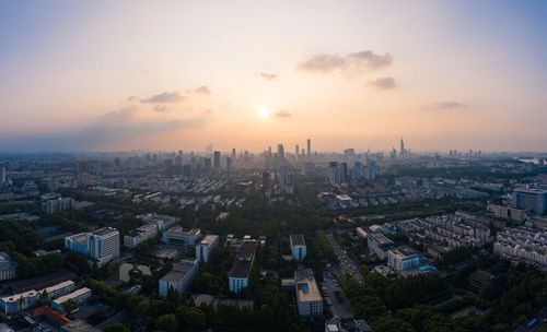 High angle view of buildings against sky during sunset