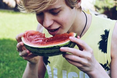 Cropped image of woman eating fruit