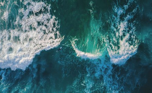 Aerial view of woman surfing in sea