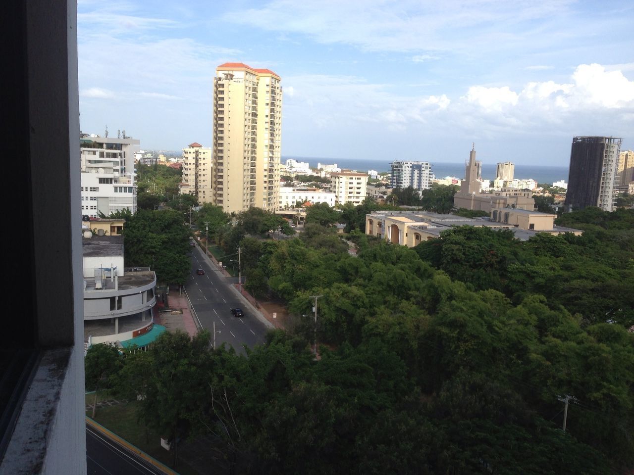 architecture, building exterior, built structure, city, tree, cityscape, sky, high angle view, cloud - sky, residential building, residential district, skyscraper, cloud, city life, residential structure, building, tower, day, water, road